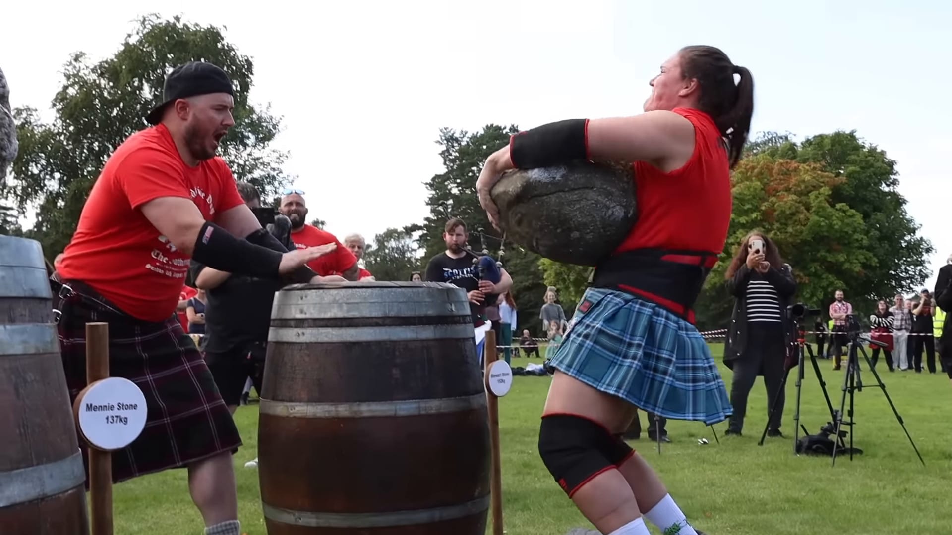 Hannah Linzay lifts a heavy stone to her chest, before placing it on a barrel in front of her.