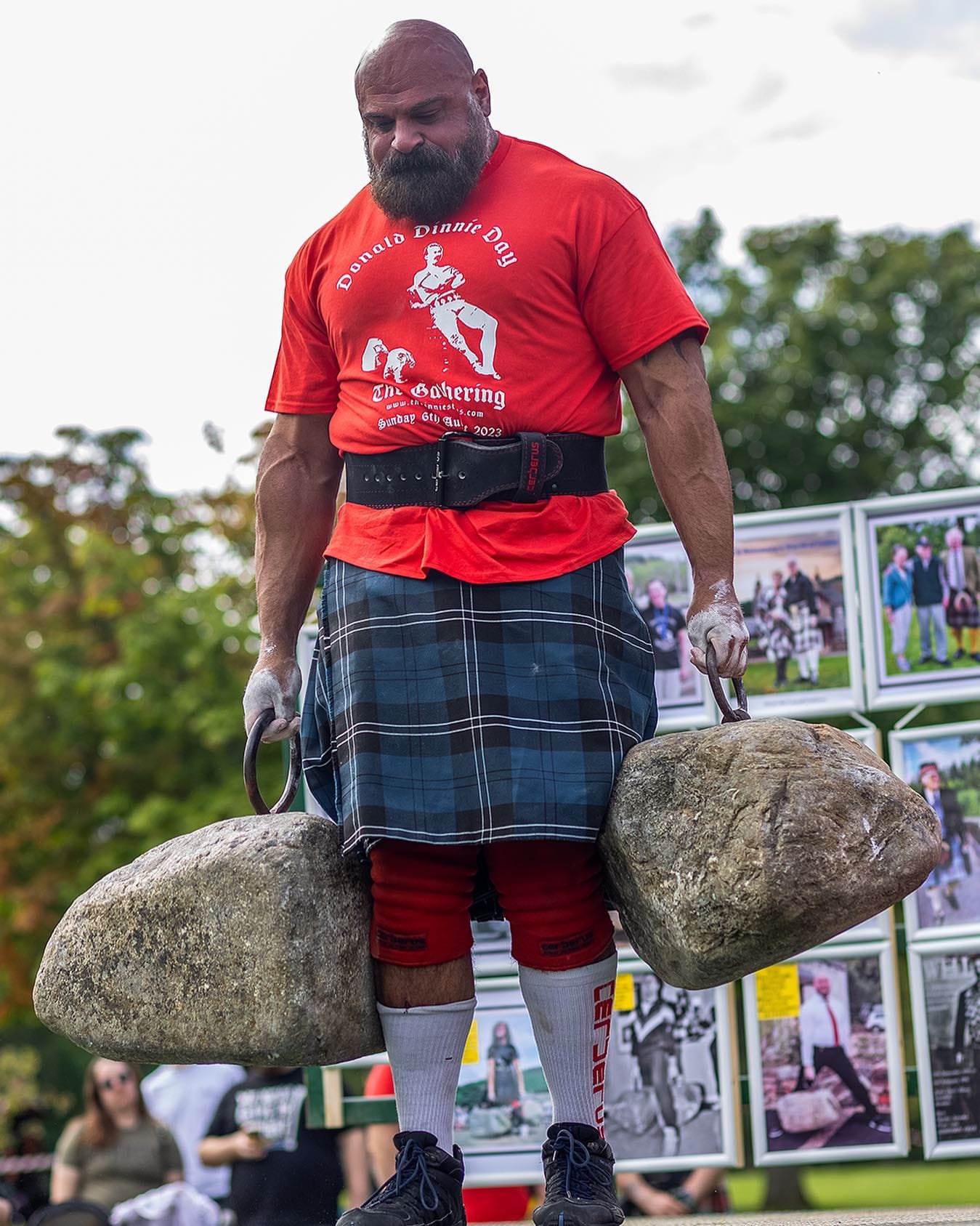 Big Loz carries the Dinnie Stones at The Gathering in 2023.