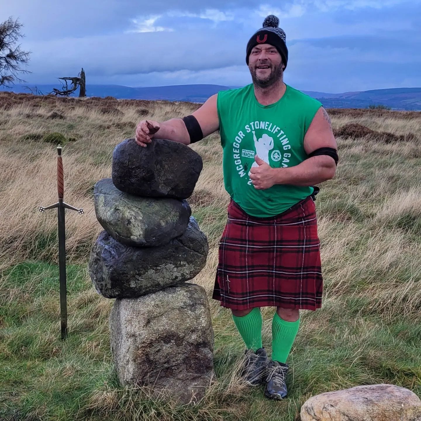 Jamie Gorrian stands next to a stack of stones.