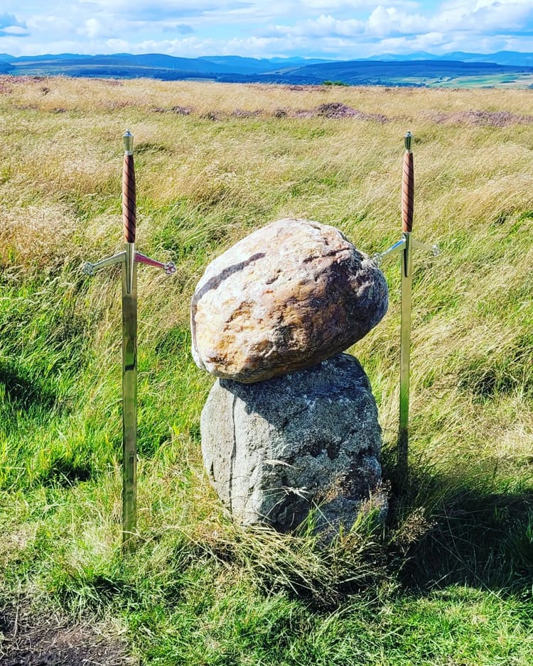 A large red stone sits atop a small plinth.