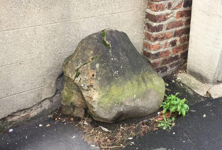 The Giant's Stone sitting on the side of the street.